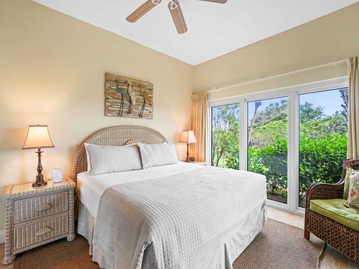King size bed with deluxe mattress and crisp white linen. Bedside tables and lamps, ceiling fan for those warm summer nights and large garden view windows.