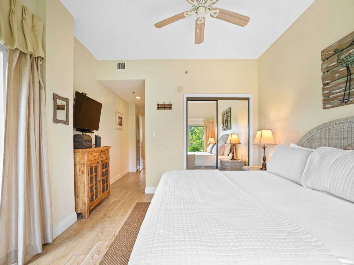 Master bedroom with ceiling fan, large double closet and smart tv.