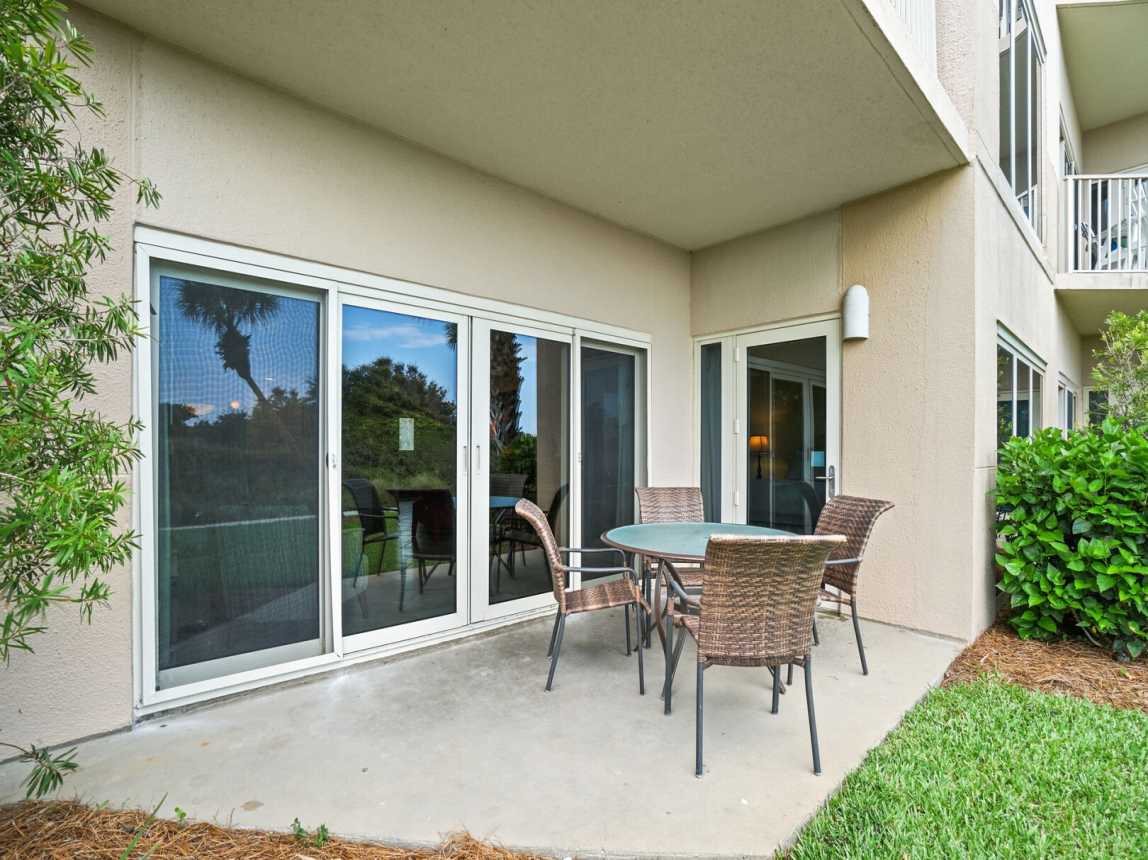 Large open patio just off the grounds of the garden with a table for 4.