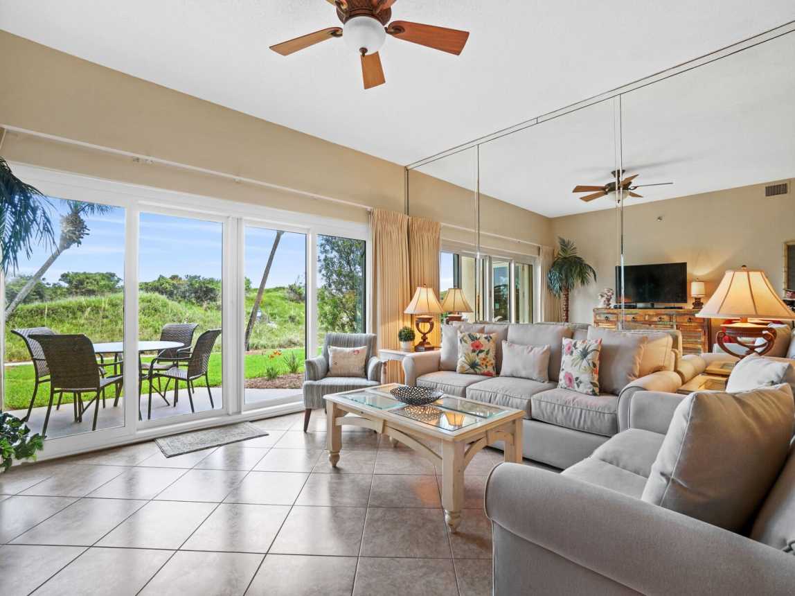 Nice view of the outdoor patio and garder area, with a walkway to the beach.