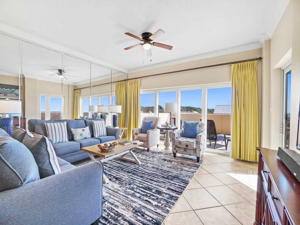 Blues and yellows make this living room come to life with the feel of the beach. Large area for everyone to have a place to sit and relax.