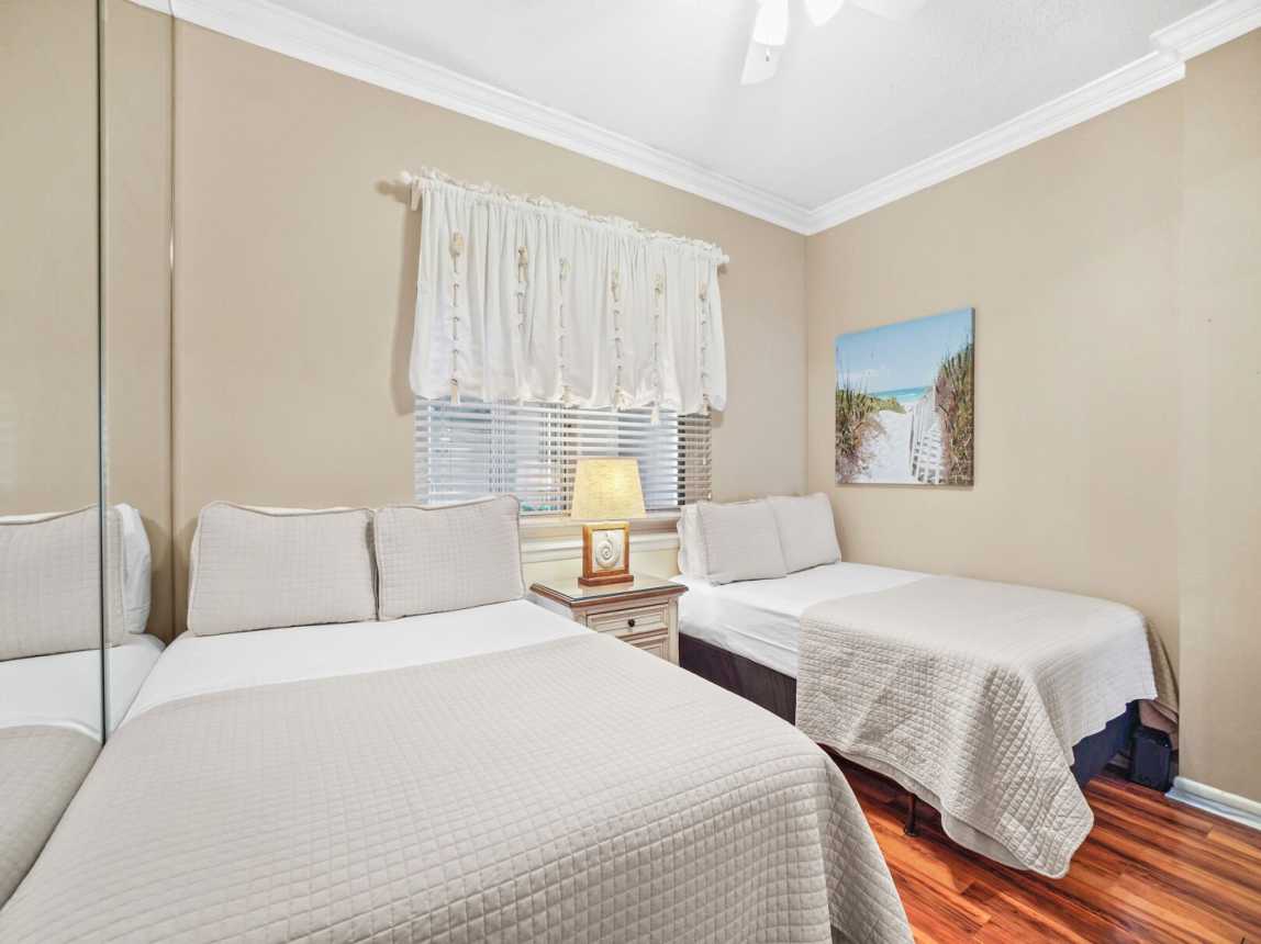 Two full size beds, a bedside table and lamp, with a ceiling fan for those warm summer nights.