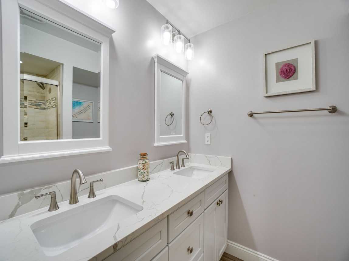 Large vanity with double sinks, and mirrors with plenty of space for two.