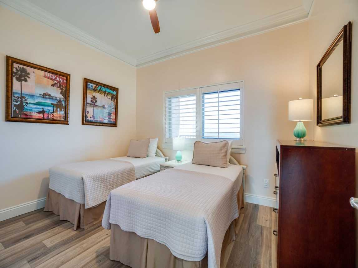 Nicely appointed guest room with comfy twin beds, and a large double window for the natural light. Dresser with plenty of drawers for putting away your wardrobe.