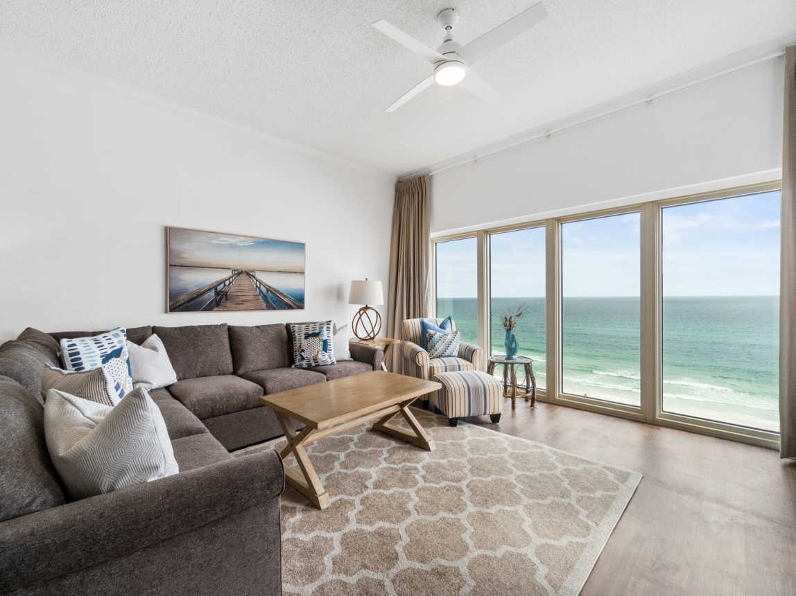 Plenty of room for all to crash, enjoy the view and just relax. L-shaped sofa, club chair with ottoman, and ceiling fan to keep it breezy. Don't forget that magnificent gulf view!