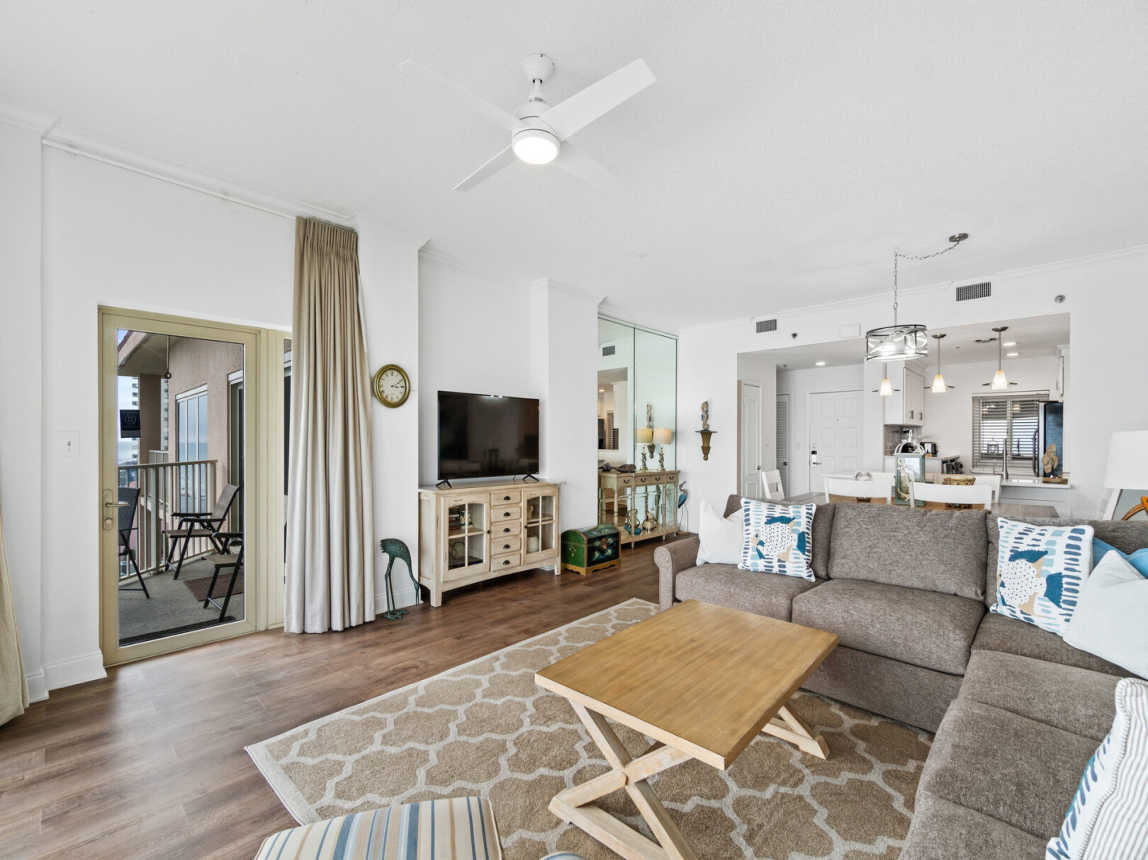 Different view from the living room into the dining area and kitchen. Entrance to 8th floor balcony.