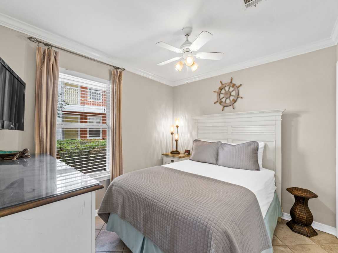 Master bedroom provides a plush queen size bed with crisp white linen and light coverlet for your evening comfort.