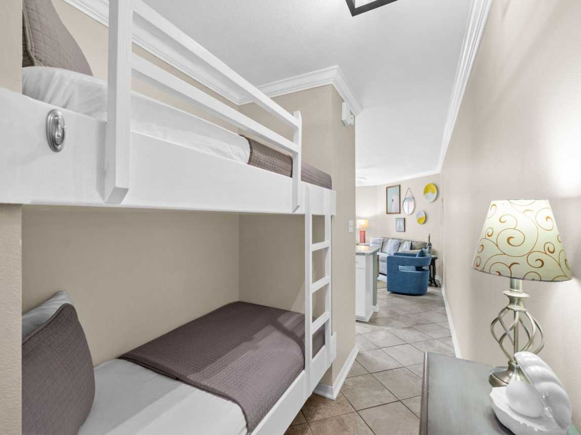 Entry hallway showing full size bunkbeds with ladder and railing.