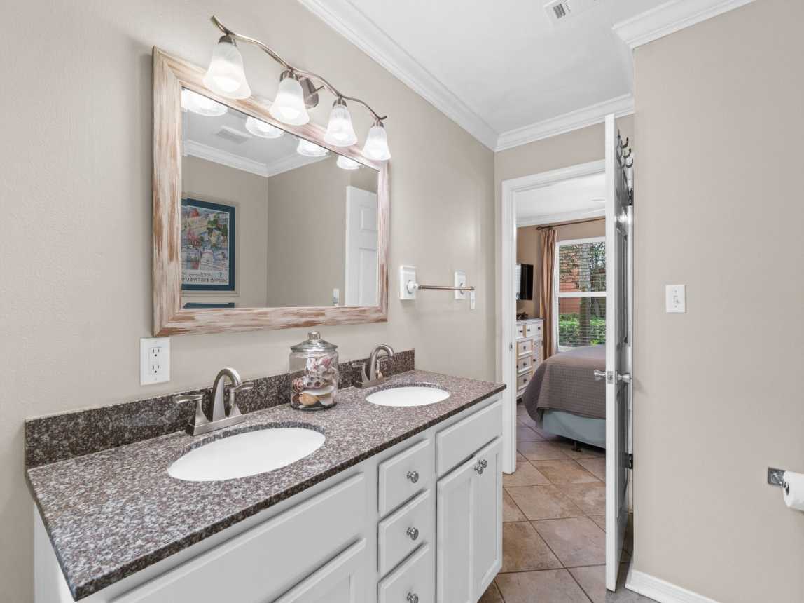 The shareable bath has a double sink with a full bath/shower combo.