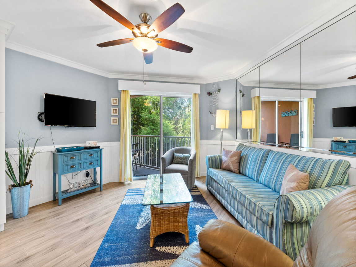 Living room featuring fresh decor done in coastal colors and art. Flat screen TV w/cable.