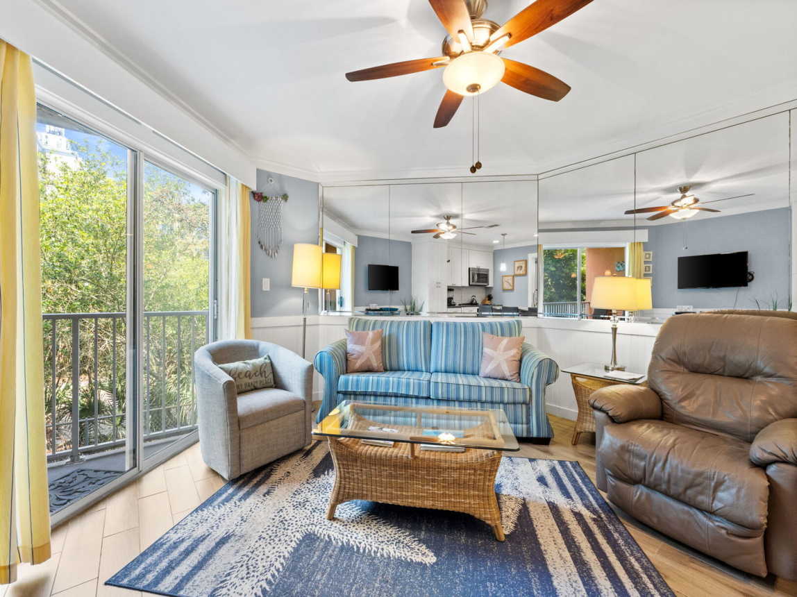 Comfortable living room with sofa, leather recliner and swivel club chair. Sliding doors out to the balcony. Sofa also provides a full size sleeper option.