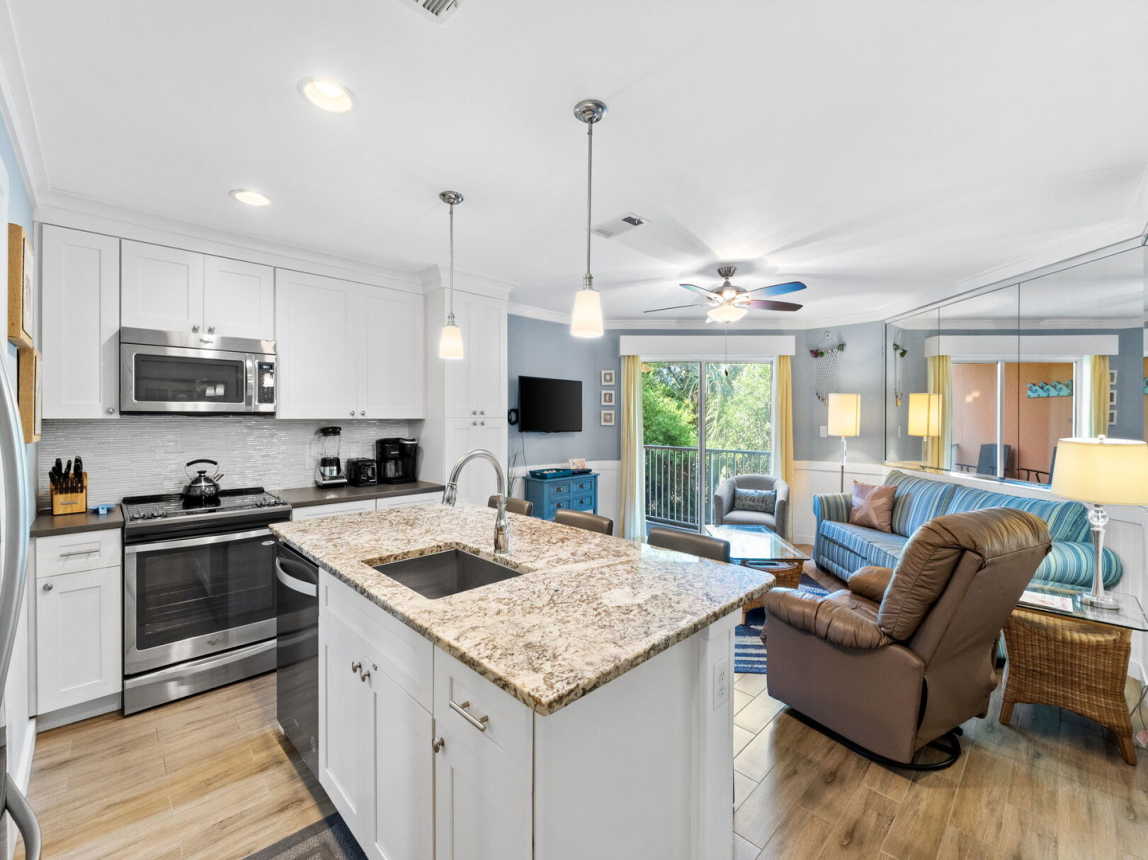 Another view of the fully stocked kitchen. Dishwasher, garbage disposal, range, microwave, refrig, coffee maker, blender, and a toaster.