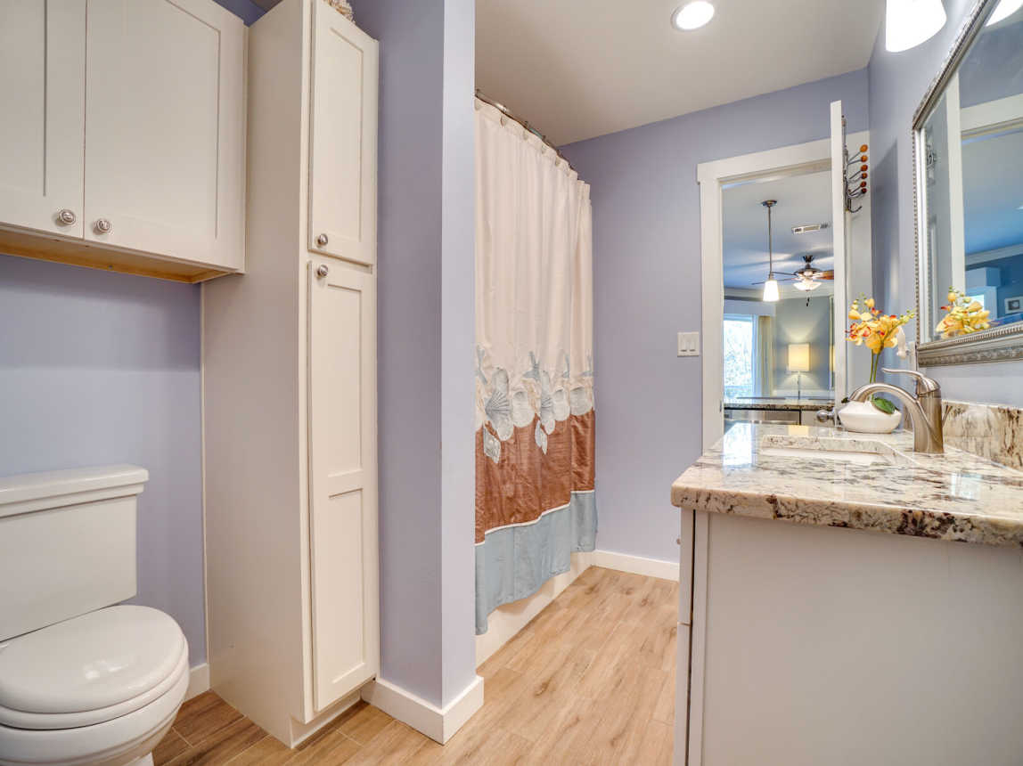 Large bathroom accessible from the kitchen and master bedroom.