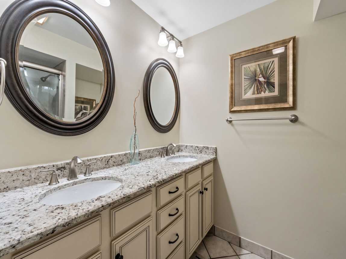 Master bath has dual vanities, double mirrors and plenty of cabinets and drawers for all your personal bath needs.