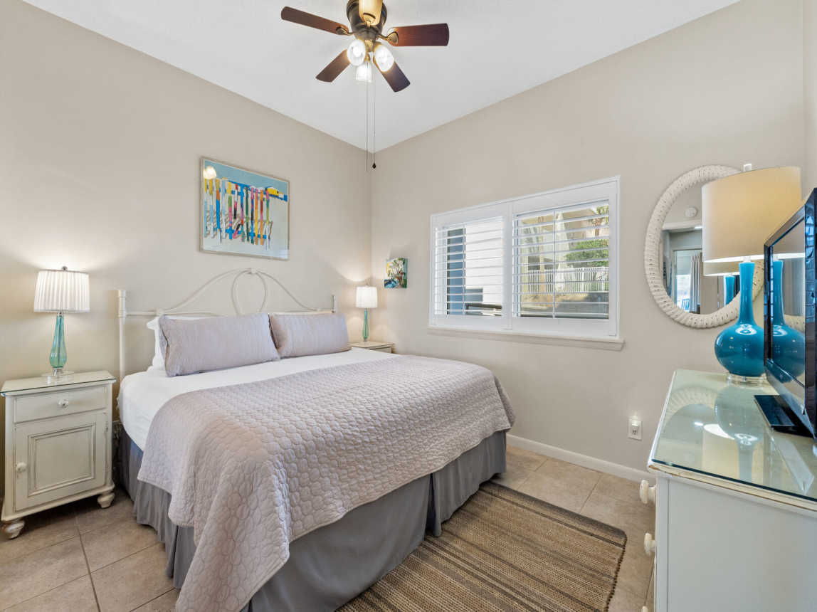 Guest suite also provides a king bed with crisp linens and light coverlet for those cooler nights as well as a ceiling fan for those warmer summer nights. There are nightstands with lamps on each side of the bed for easy reading.
