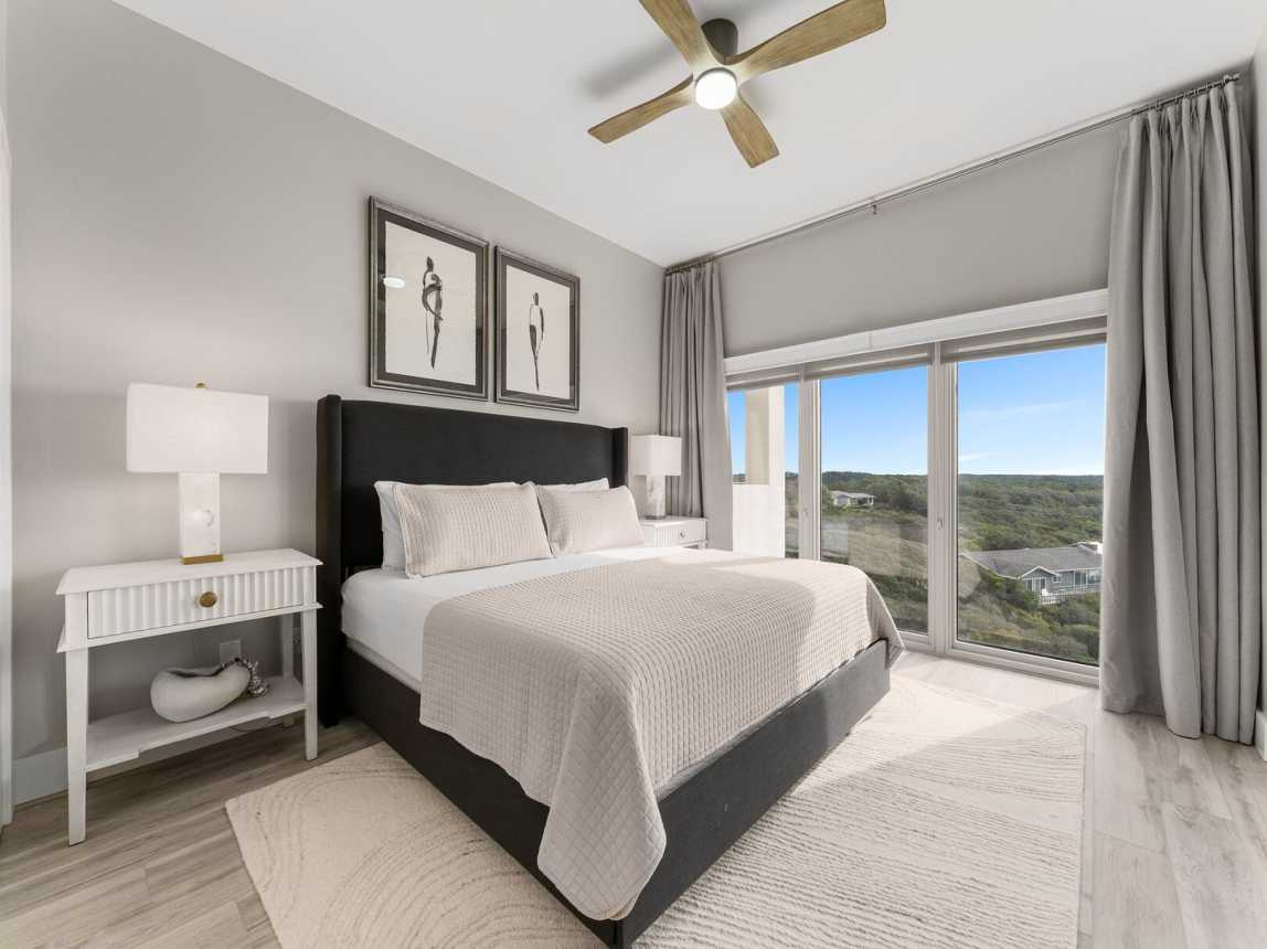Master suite with king size bed, 2 night tables and lamps, ceiling fan for warm summer nights and floor to ceiling windows for that perfect beautiful view.
