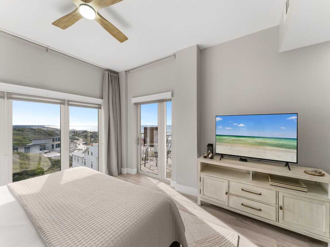 Master has a large screen TV, private balcony entrance, and dresser.