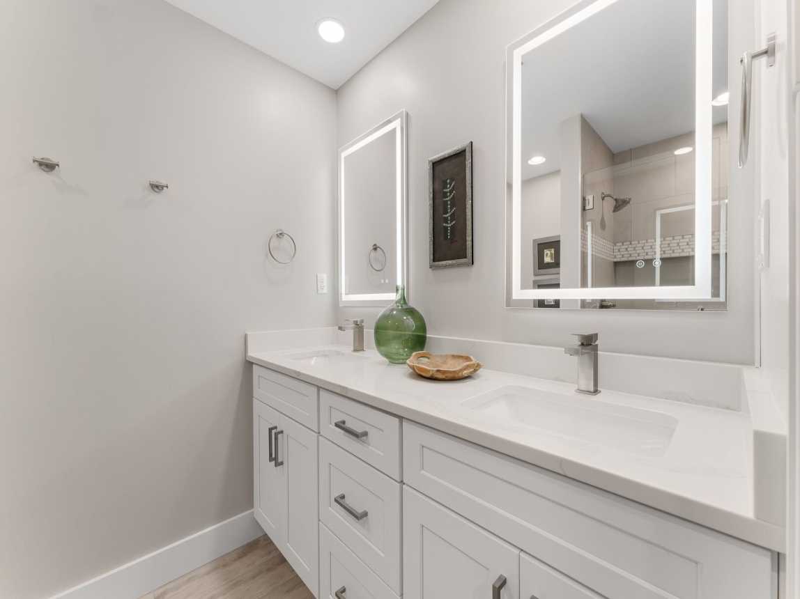 Master bath provides a double vanity, two lighted mirrors and plenty of cabinet storage for all your bathroom necessities.