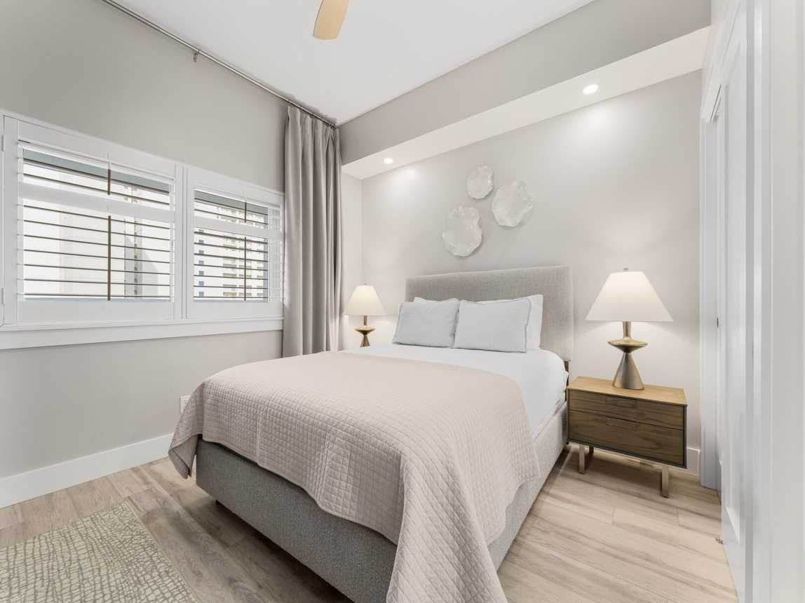 Guest bedroom has queen size bed, 2 night tables and lamps, and ceiling fan for warm summer nights.