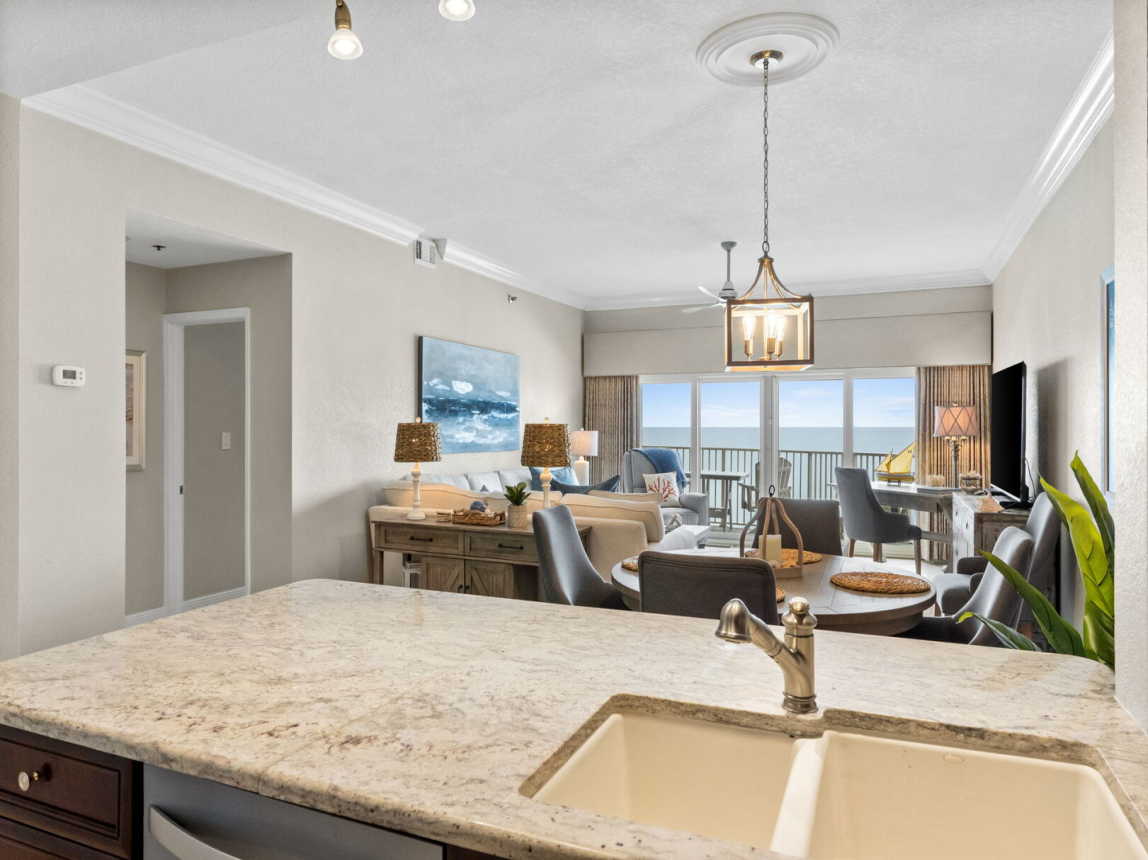 View from kitchen of dining room into living room and balcony.