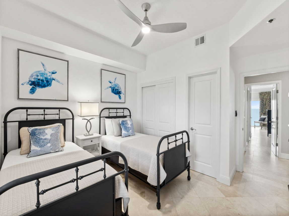 Guest Bedroom with 2 very comfortable twin beds, nightstand with table lamp, closet and private entry to guest bathroom.