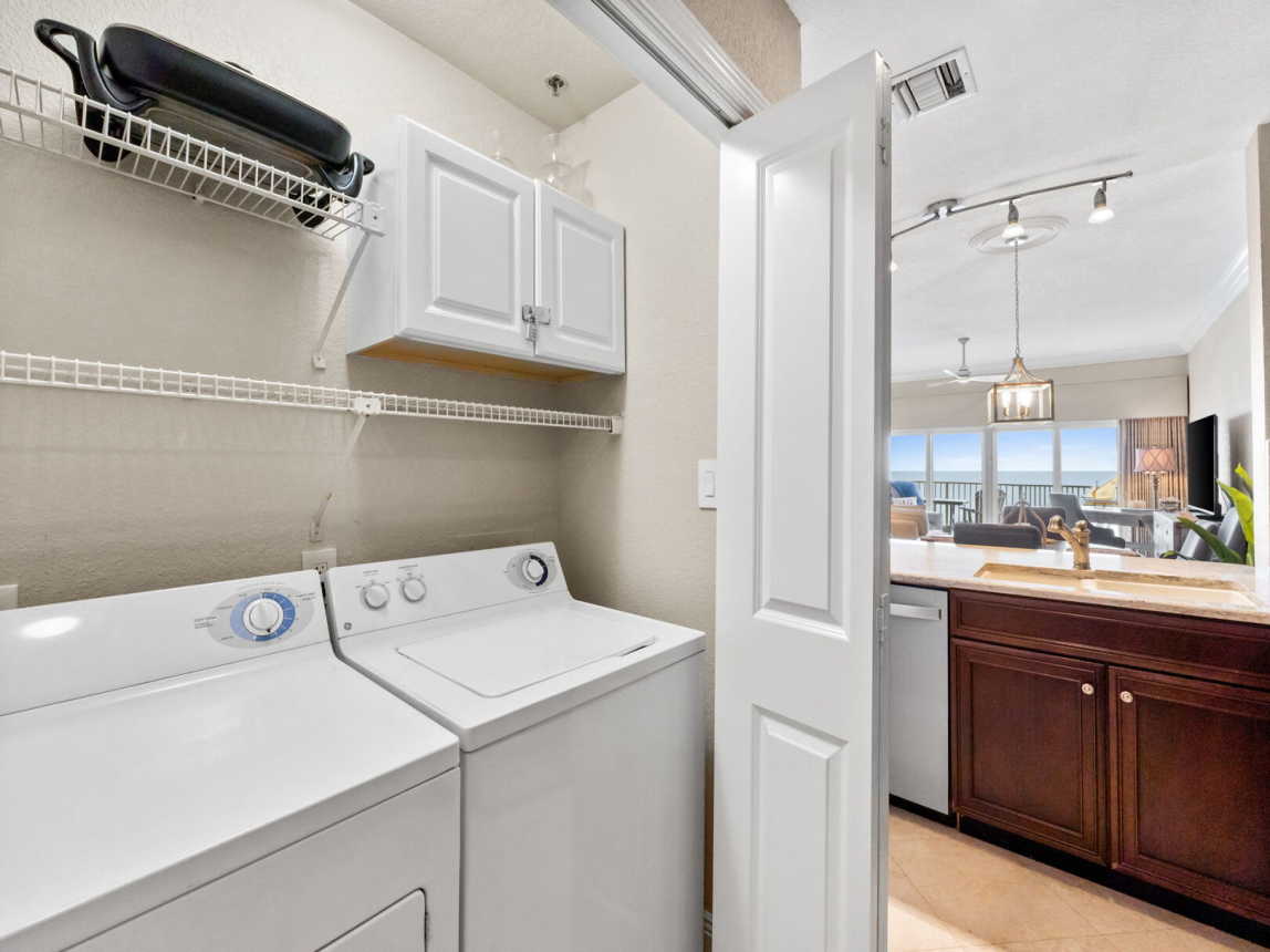 Washer and dryer in closet in kitchen.