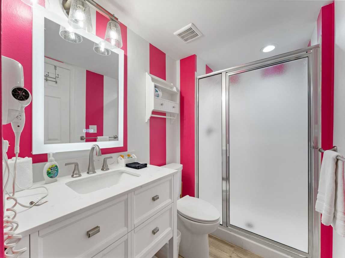 Guest bath offers a full step in shower and single vanity.