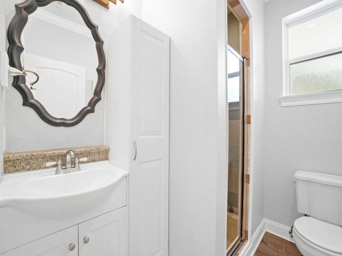 1st floor just off the kitchen full bath with vanity, and step in shower.