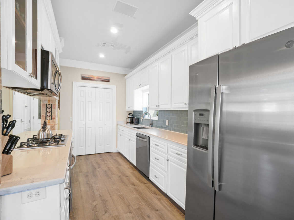Enjoy this open galley type kitchen with all stainless steele appliances, dinnerware, cookware, and drinkware for those times you just don't feel like going out.