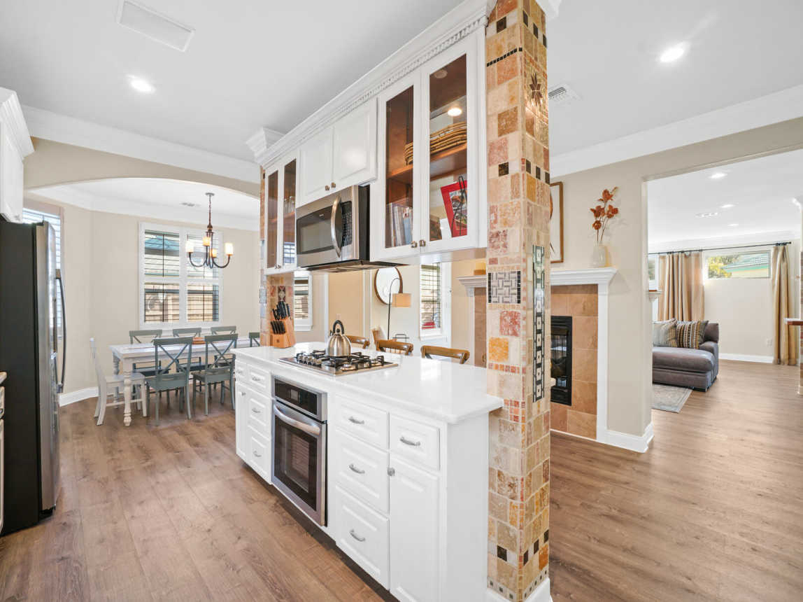 Microwave, cooktop and oven. Dining area close by.