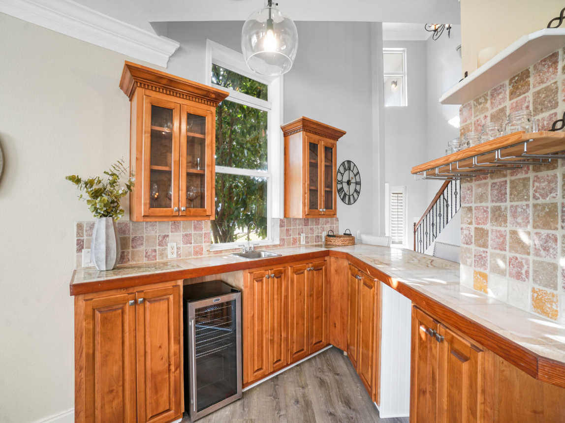 Spacious kitchen type bar area with beverage cooler, barware and all other esentials to entertain.