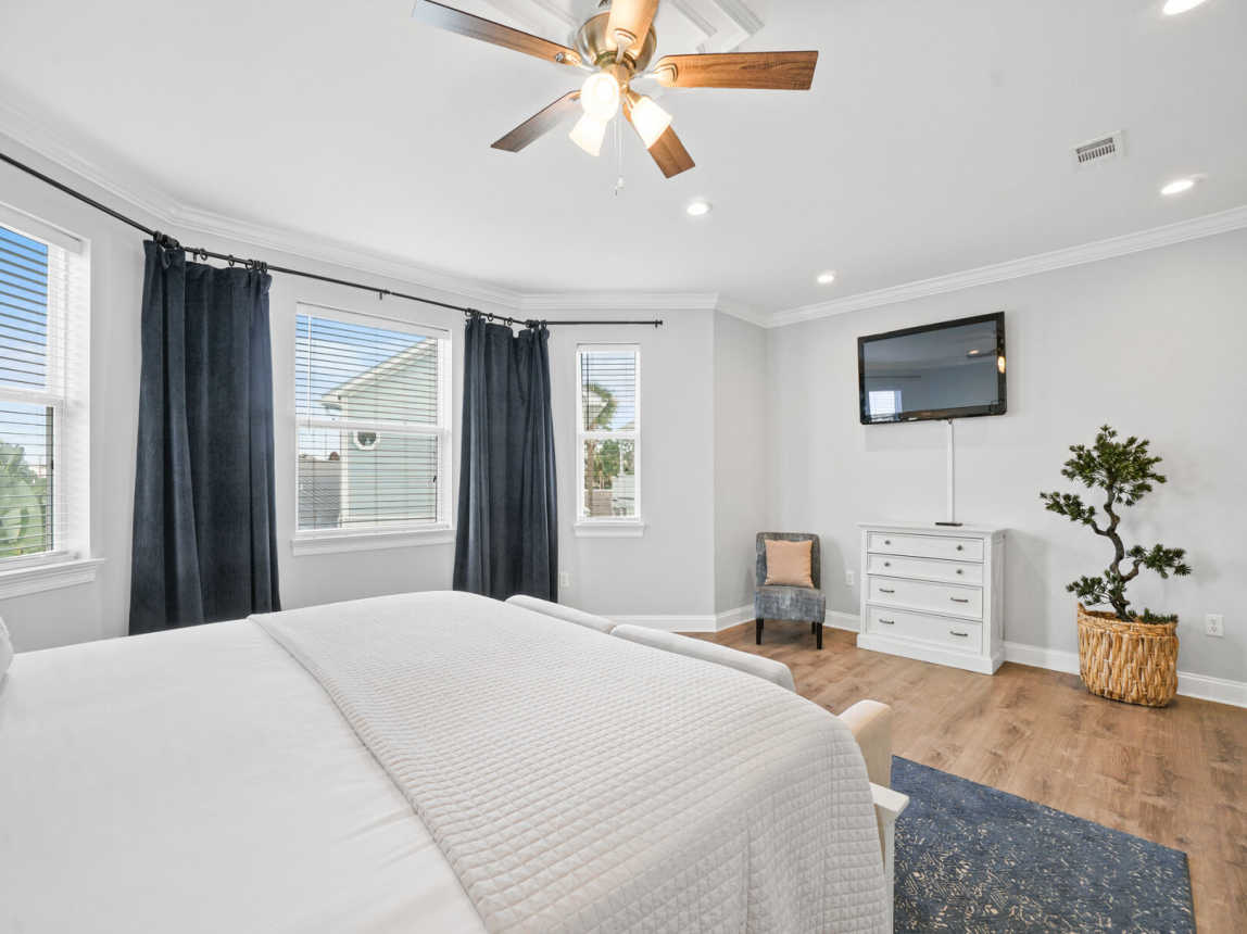 Master bedroom showing large bay type windows for great natual light, large flat screen TV with cable.