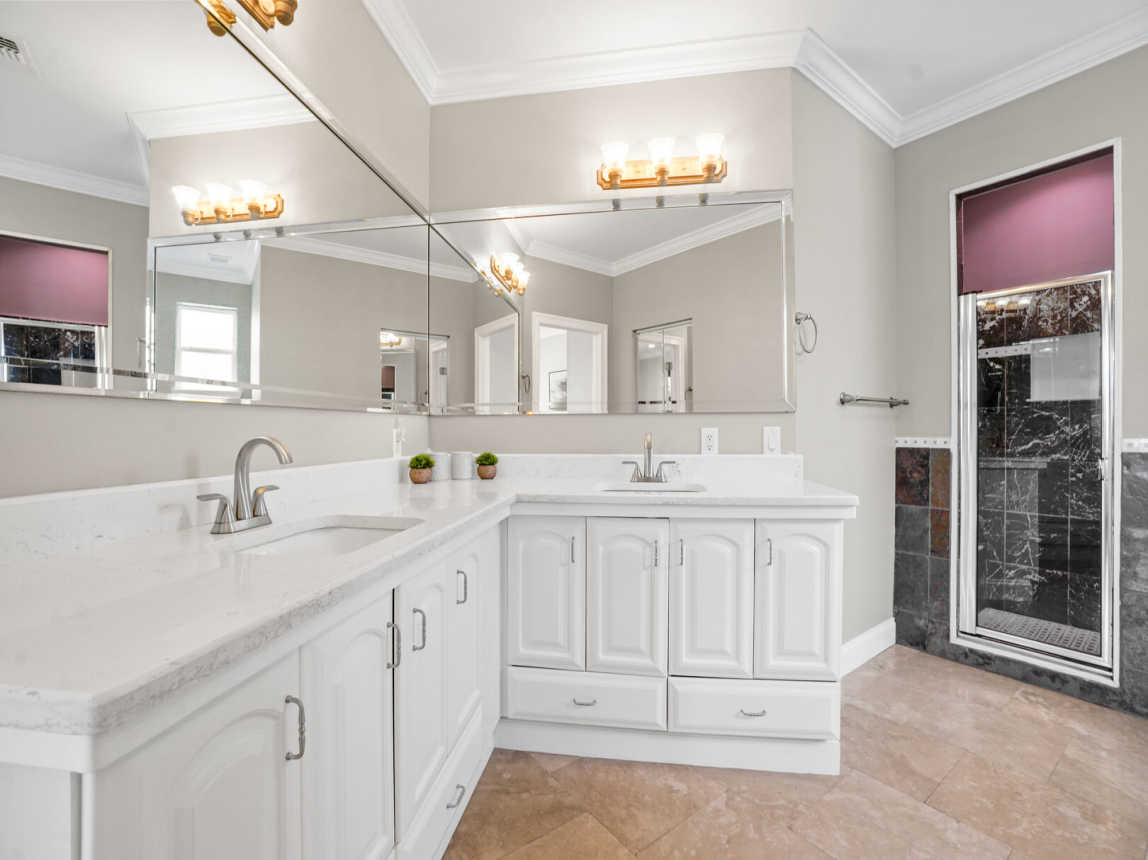 View of the double vanity, and step in shower.