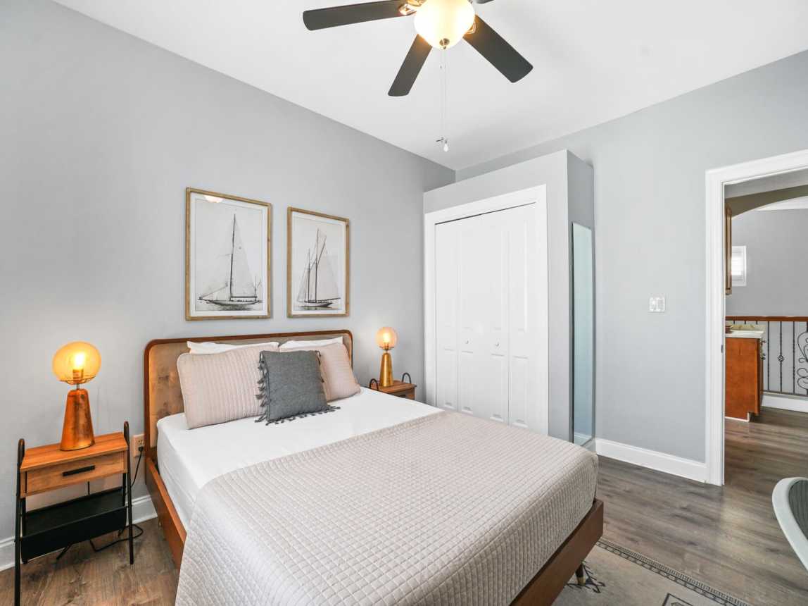 Just at the top of the stairs to your right a queen room, with plenty of closet. Bathroom just outside your door - shared with 2nd queen room.