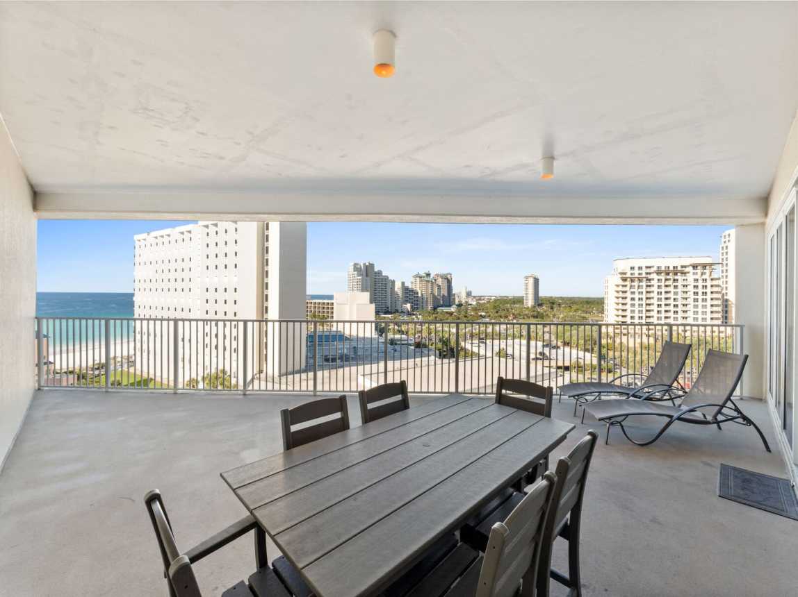 Oversize balcony with lounge chairs and a tdining table for 6.