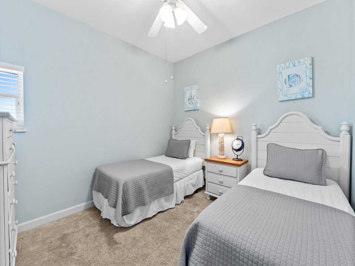 Room guest room with twin beds, fluffy pillows, crisp white linens.