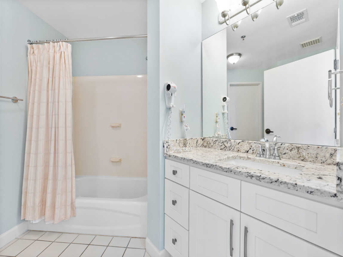 Gust bath with single sink vanity, and full mirror. Pleaty of storage and counter space