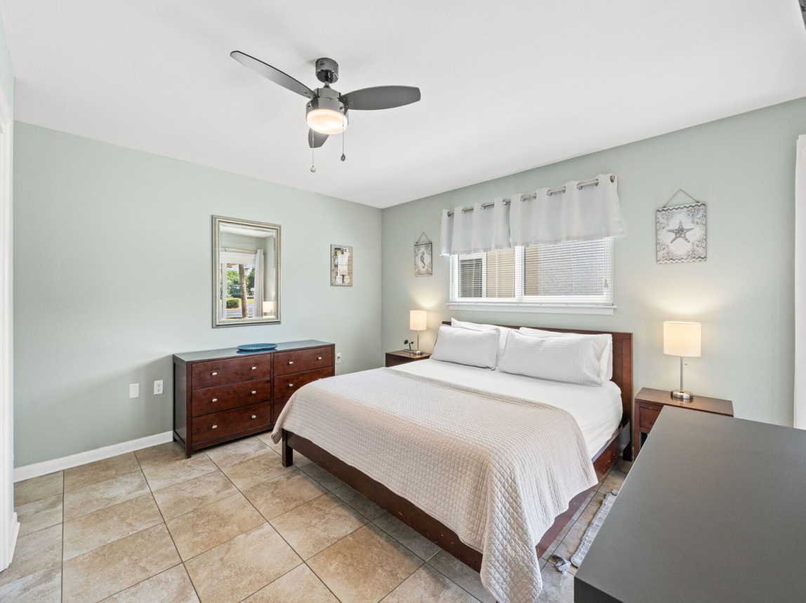Large, oversize master suite with plenty of natural light and a lush king size bed.