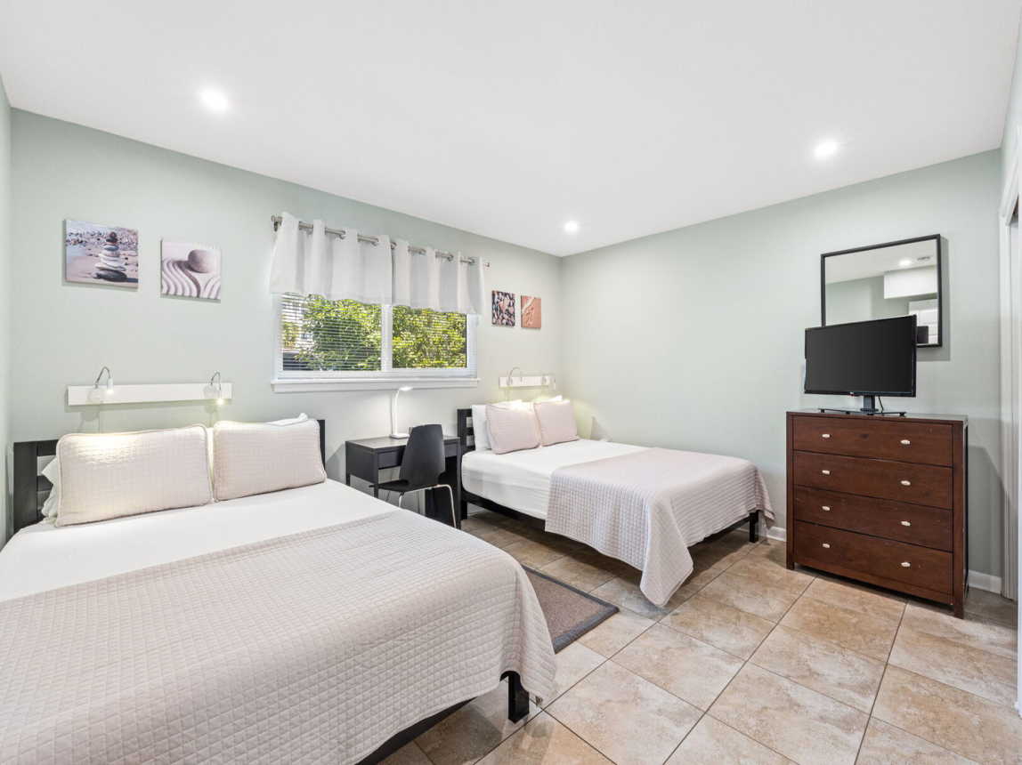 Large Guest room provides 2 queen beds, night lighting, small desk, flat screen tv with cable hook up and wi-fi.