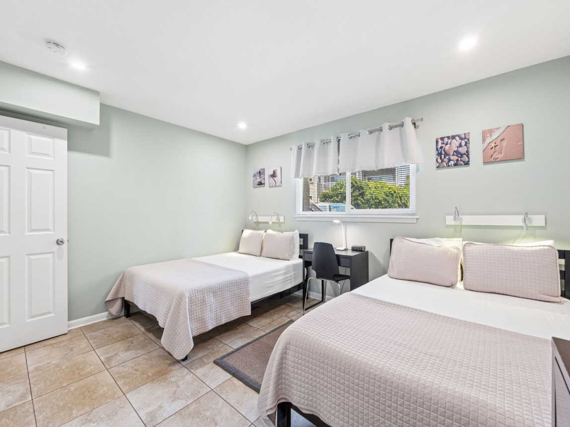 Guest room - 2 queen beds, fresh linen, comfortable bedding, winddow providing natural light and a full size closet.