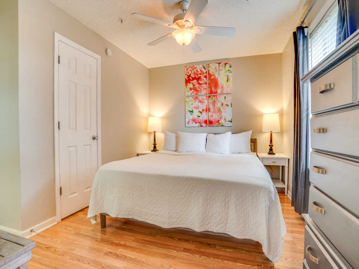 King bed, closet, 2 lamps and nightstands. Floor to ceiling drapes for privacy.