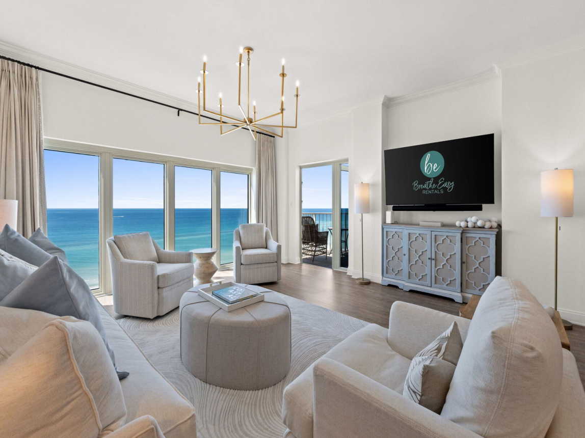 The spacious living room comfortably seats 5, featuring a smart TV and an open layout perfect for chatting while cooking! ---