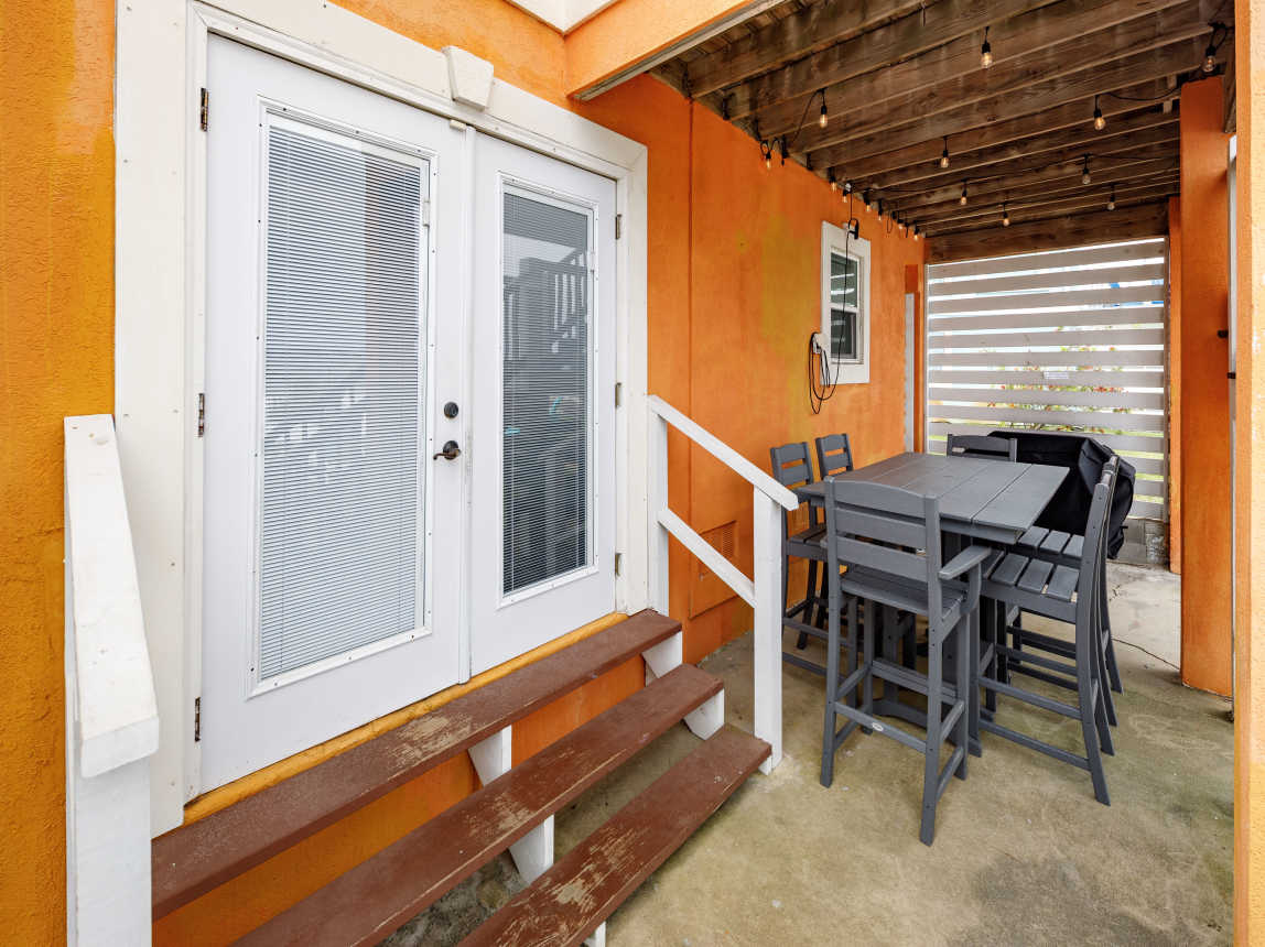 Back of home with french doors to the guest suite and gaming room