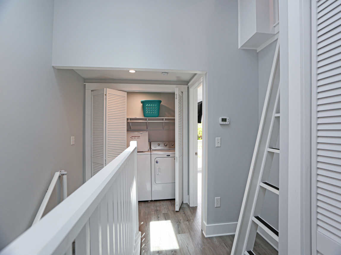 Upstairs Hallway with Laundry Closet and Ladder to Loft