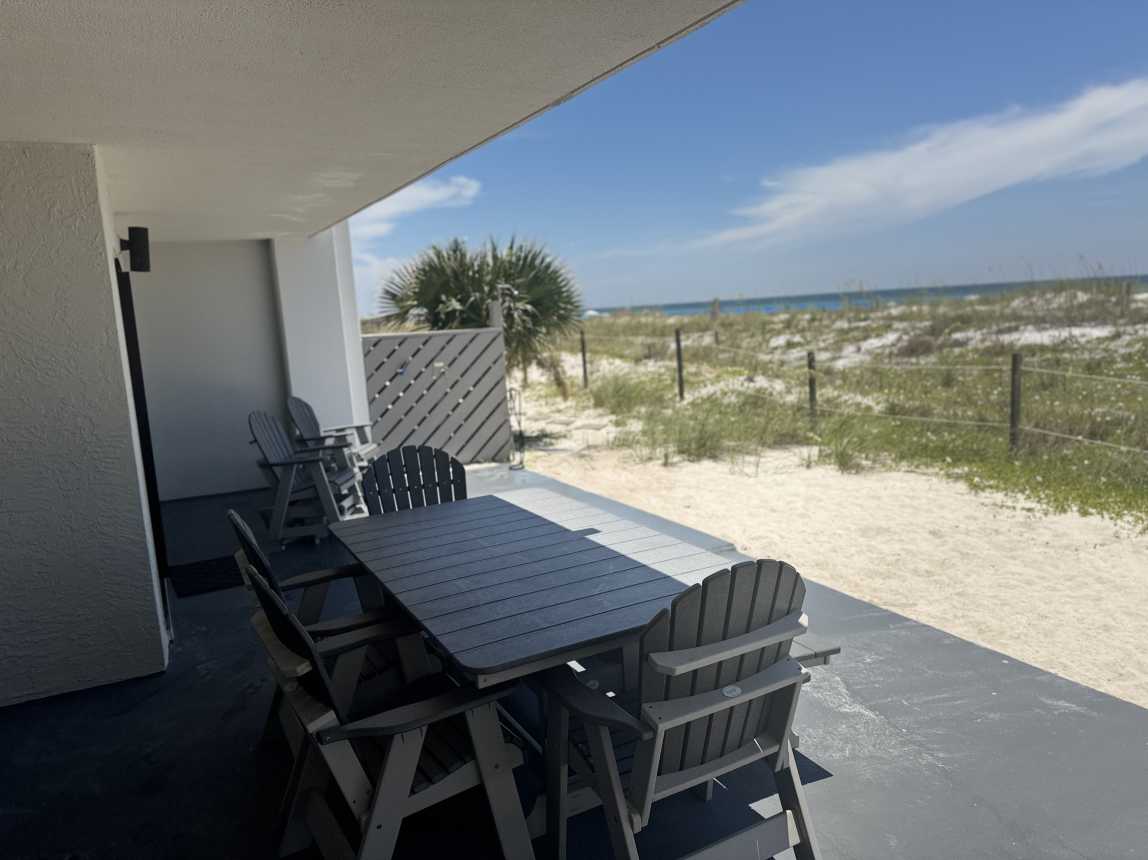 Gulf front porch with shower and hose to wash off after a day at the beach