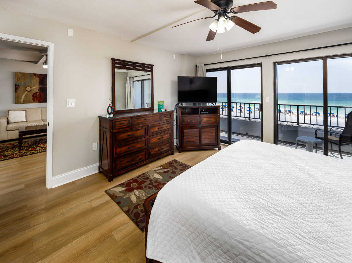 Master bedroom with TV and balcony access