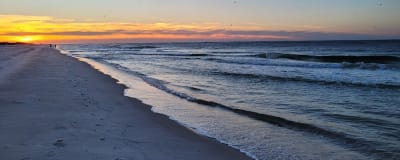 Enjoy the sunrise while listening to the sound of the waves while walking on the white sands of bama