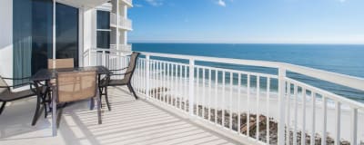 Paradise!!  Balcony seating for 4. Also includes reclining lounger (not shown). Access balcony from living area or master suite.