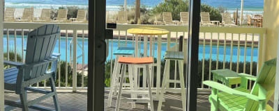 LIFE IS GOOD on this balcony with 2 table sets and Adirondack chair. TOYS TOO!