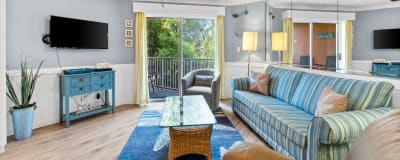 Living room featuring fresh decor done in coastal colors and art. Flat screen TV w/cable.